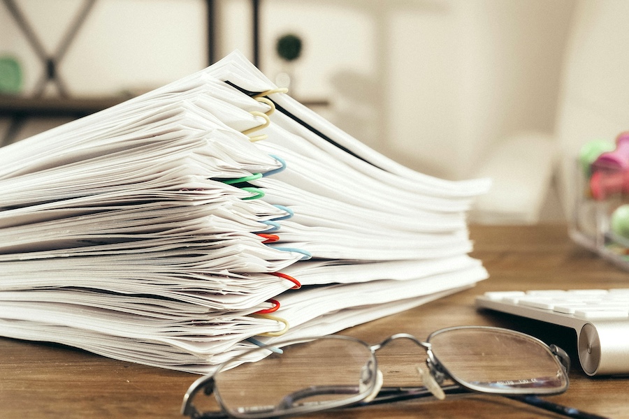 Large stack of resumes on a manager's desk.