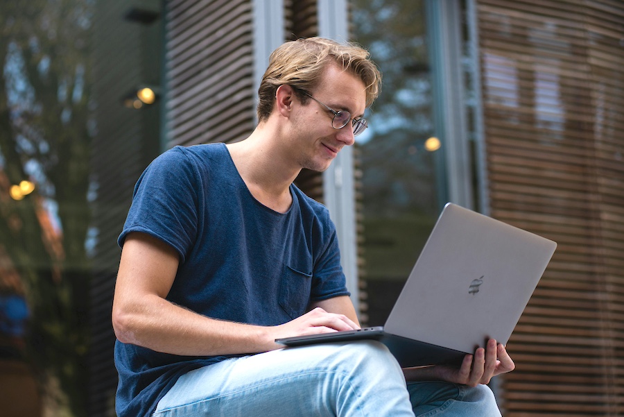 Smiling man working on an online job application.