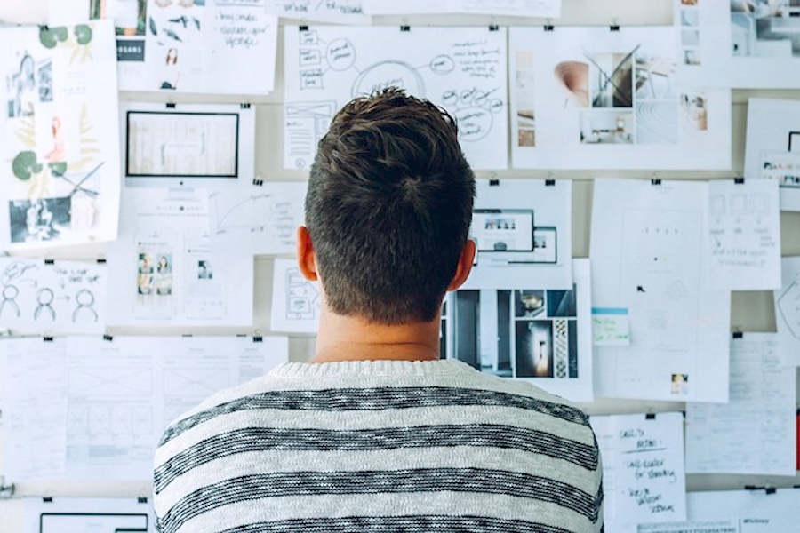 Man looking at a vision board.