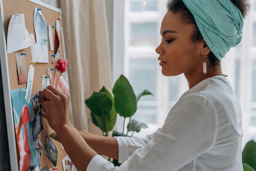 An office worker creating a vision board.