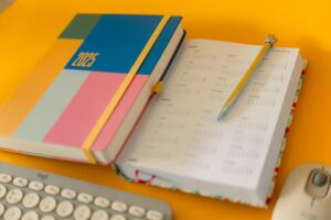 A new planner next to a computer keyboard.