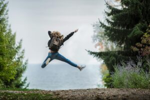 Happy woman jumping in nature.