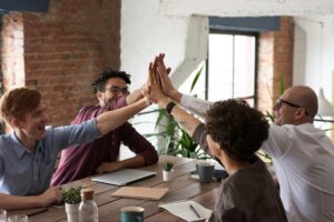 Coworkers giving each other high fives.