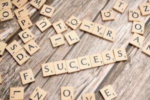 Scrabble tiles spelling out success.