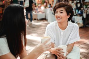 Two women talking about opportunities over coffee.